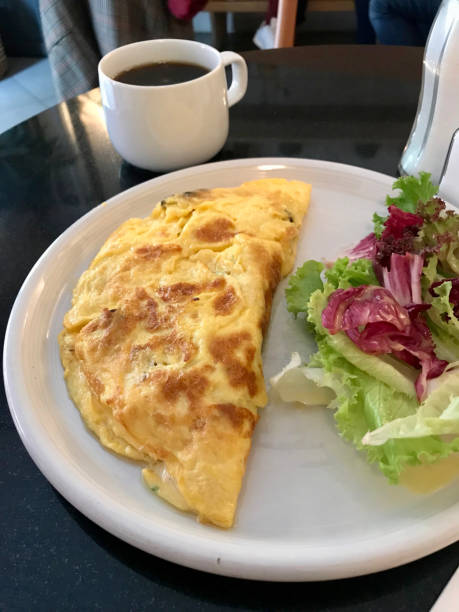 istock Omelette served with Fresh Salad and Coffee for Breakfast at Restaurant. 1058271932