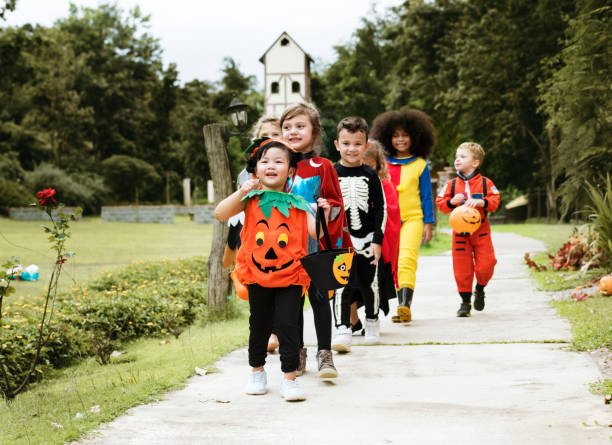 istock Young kids trick or treating during Halloween 1058274746