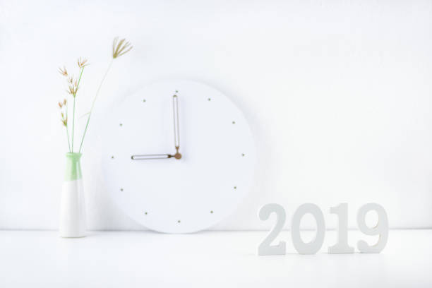 istock 2019 happy new year theme, professional designer office concept : Business work space / modern workplace and decorative supplies place on desk table e.g number 2019 white wood cut, wall clock, vase 1058276382