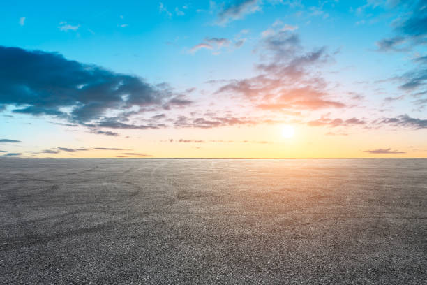 istock Car racing track asphalt square and beautiful sky clouds scenery at sunset 1058277120