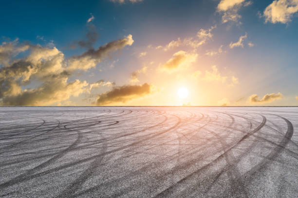 istock Car racing track asphalt square and beautiful sky clouds scenery at sunset 1058280544
