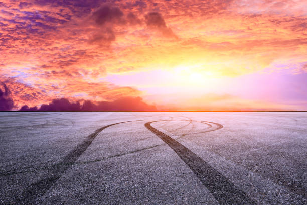istock Car racing track asphalt square and beautiful sky clouds scenery at sunset 1058281842