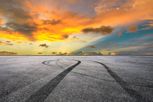 istock Car racing track asphalt square and beautiful sky clouds scenery at sunset 1058282252