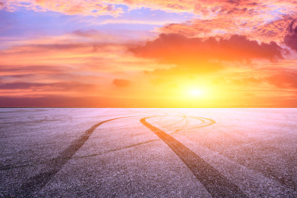 istock Car racing track asphalt square and beautiful sky clouds scenery at sunset 1058283432