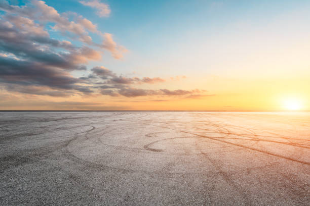 istock Car racing track asphalt square and beautiful sky clouds scenery at sunset 1058284644