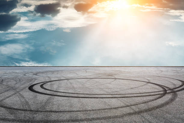 istock Car racing track asphalt square and beautiful sky clouds scenery at sunset 1058285494