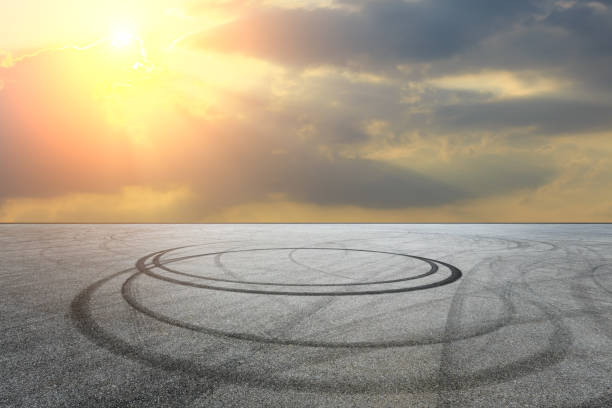 istock Car racing track asphalt square and beautiful sky clouds scenery at sunset 1058285950