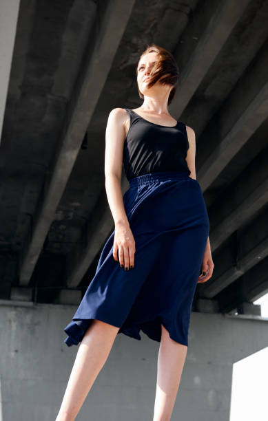 istock young girl posing under the bridge, dressed in black, modern architecture 1058289354