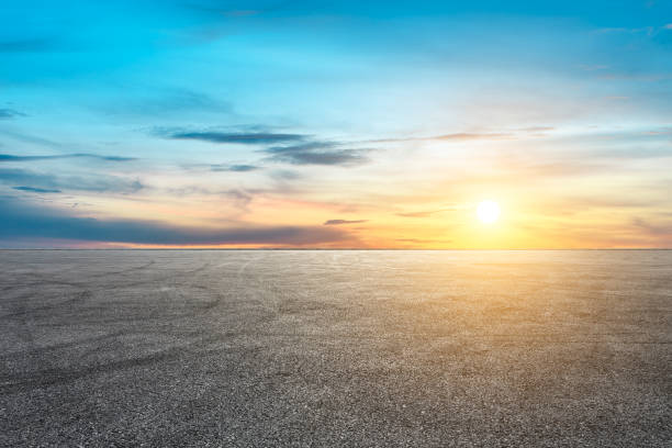 istock Car racing track asphalt square and beautiful sky clouds scenery at sunset 1058293506