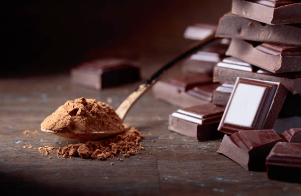 istock Broken  chocolate pieces and cocoa powder . 1058293764