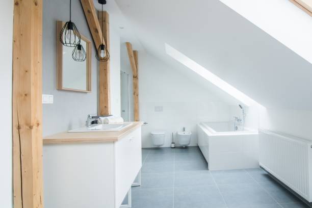 istock Bright modern bathroom with grey walls, mirror and bathtub. 1058294250