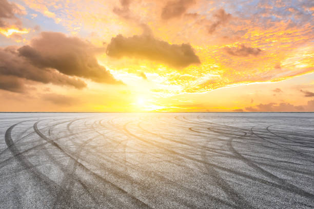 istock Car racing track asphalt square and beautiful sky clouds scenery at sunset 1058294348
