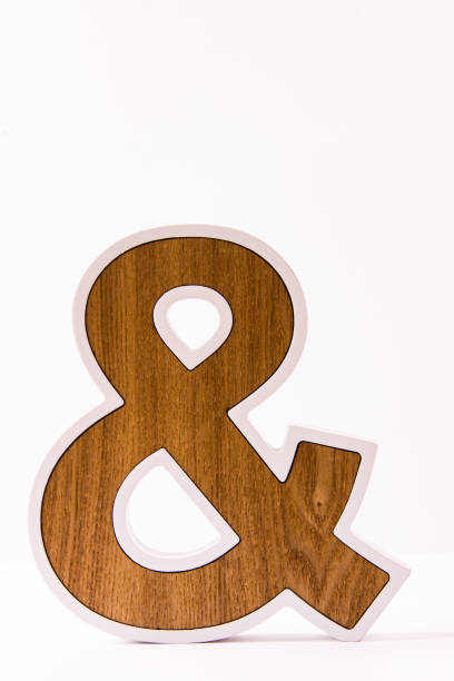 istock Wooden ampersand on white background 1058294500