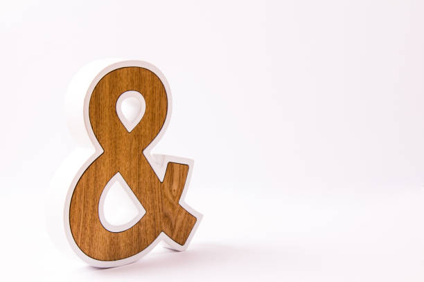istock Wooden ampersand on white background 1058294502