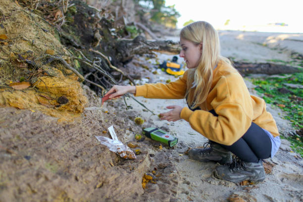 istock Final year female Geology student taking coastal rock samples and using a GPS to pin point her position in the South of England as part of her final year Geology dissertation on sea level changes in the UK 1058294610
