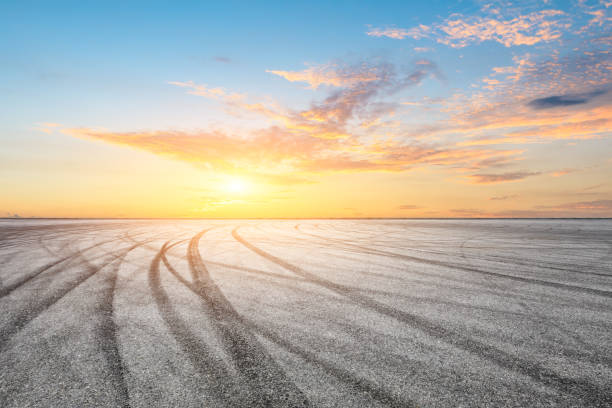 istock Car racing track asphalt square and beautiful sky clouds scenery at sunset 1058294692