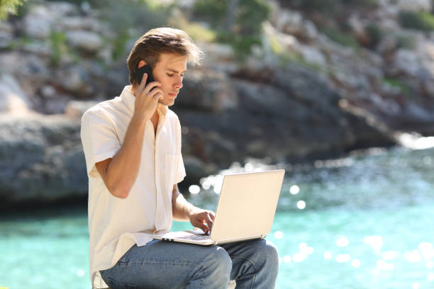 istock Customer calling on phone consulting laptop on vacation 1058294712