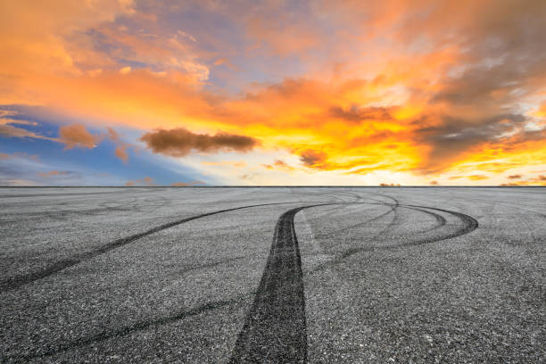 istock Car racing track asphalt square and beautiful sky clouds scenery at sunset 1058296052