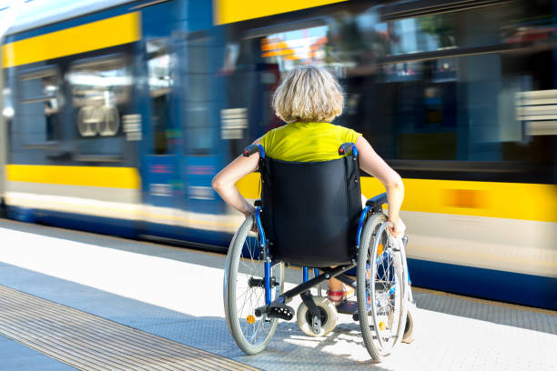 woman sitting on wheelchair on a platform stock photo