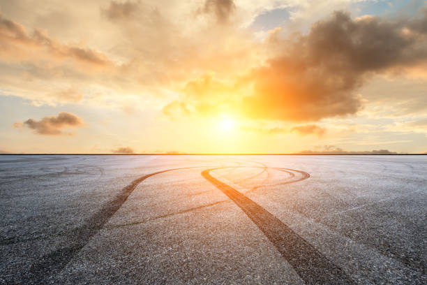 istock Car racing track square and sky beautiful clouds scenery 1058298940