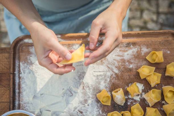 istock chef preparing handmade stuffed pasta tortellini 1058299310
