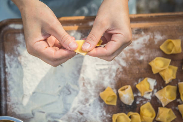 istock chef preparing handmade stuffed pasta tortellini 1058299312