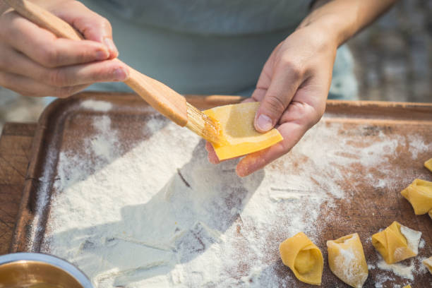 istock chef preparing handmade stuffed pasta tortellini 1058299316