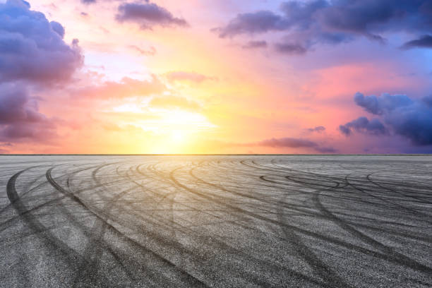 istock Car racing track square and sky beautiful clouds scenery 1058300030