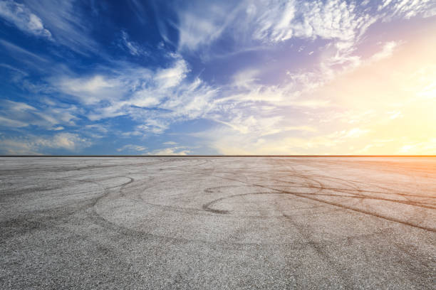 istock Car racing track square and sky beautiful clouds scenery 1058300096