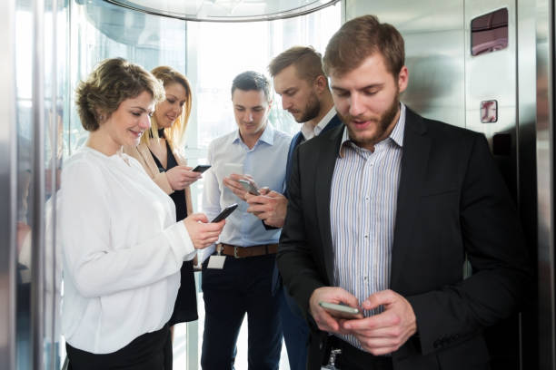 istock Business people texting in the elevator 1058300294
