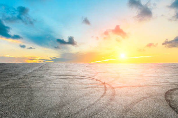istock Car racing track square and sky beautiful clouds scenery 1058300400