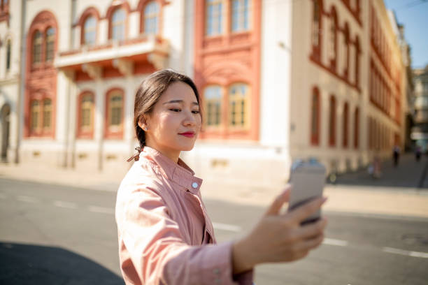 istock Asian tourist taking profile selfie 1058301940