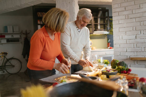 istock Senior couple cooking together 1058302612
