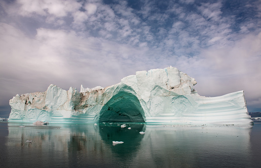 Iceberg floating in the water off the coast of Greenland. Nature and landscapes of Greenland.