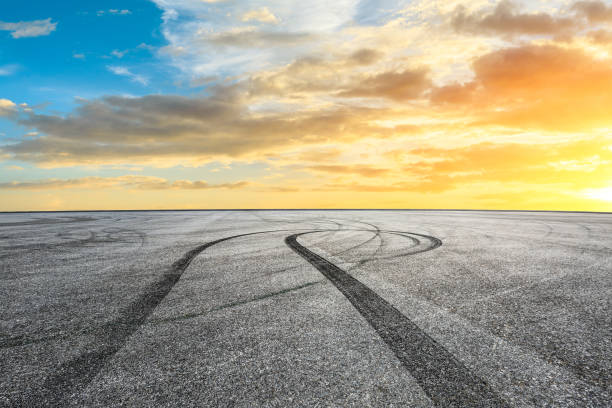 istock Car racing track square and sky beautiful clouds scenery 1058304796