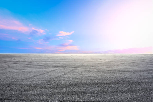 istock Car racing track square and sky beautiful clouds scenery 1058305082