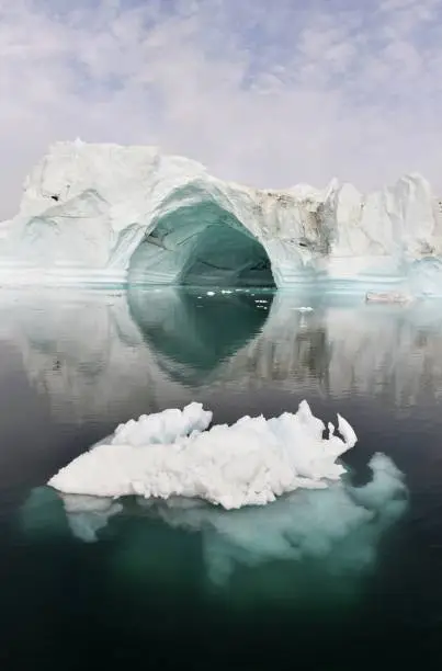 Iceberg floating in the water off the coast of Greenland. Nature and landscapes of Greenland.