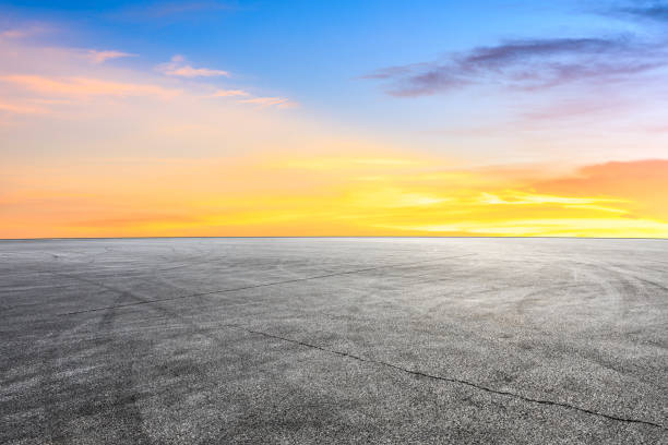 istock Car racing track square and sky beautiful clouds scenery 1058306532