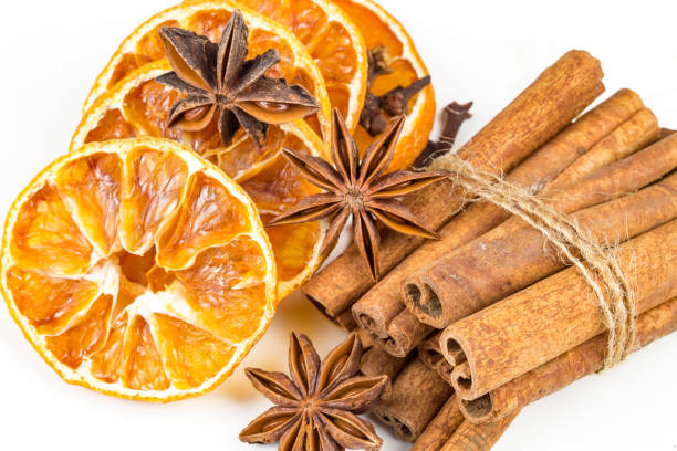istock Dried orange slices, cinnamon and star anise isolated on white 1058310092