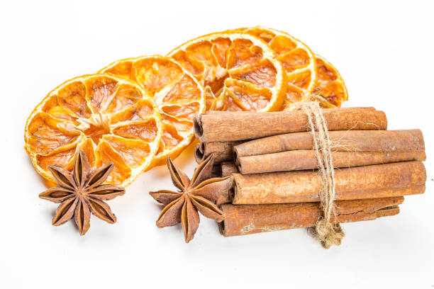 istock Dried orange slices, cinnamon and star anise isolated on white 1058310412