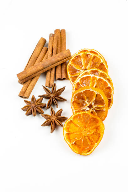istock Dried orange slices, cinnamon and star anise isolated on white 1058310514