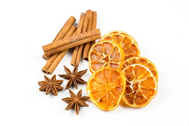 istock Dried orange slices, cinnamon and star anise isolated on white 1058310682