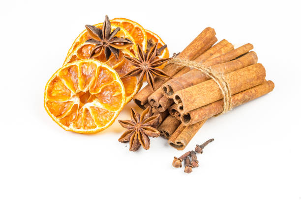 istock Dried orange slices, cinnamon and star anise isolated on white 1058312382