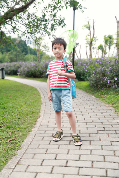 istock Child playing by a stream fishing 1058312622