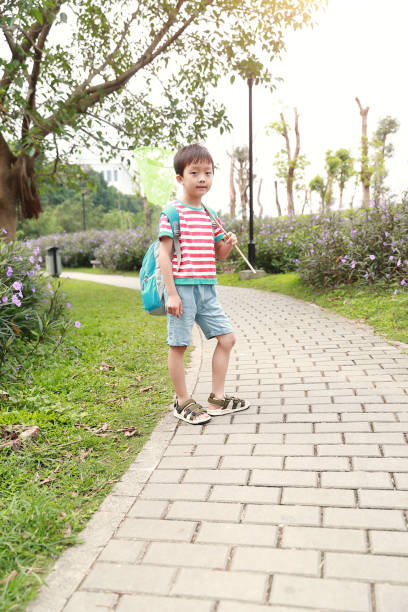 istock Child playing by a stream fishing 1058312644