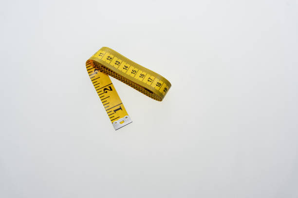 istock Yellow centimeter to measure different things on a white background 1058316386
