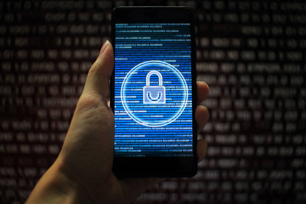 istock data privacy. surfing through hostile internet and hackers probe and bad government surveillance. blue padlock on mobile device on panel of red code led screen. hand holding smart phone. 1058320936