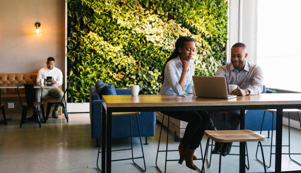 istock Young adults working in casual office environment 1058323180
