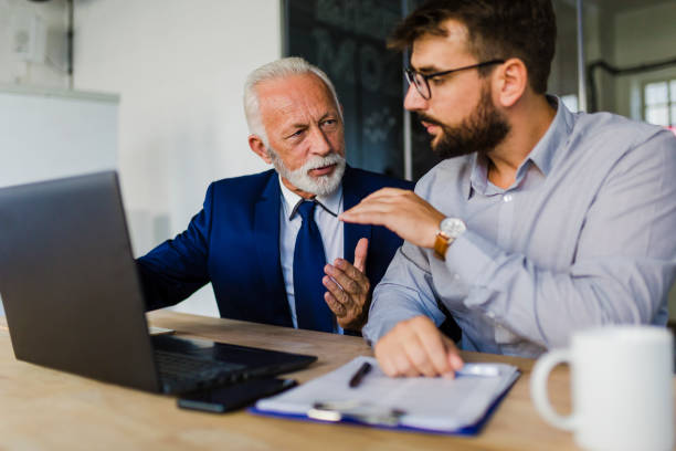 istock Two business people discussing at the office 1058323534