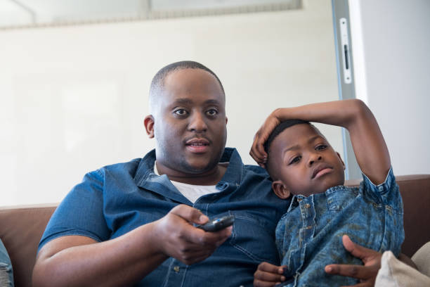 istock Father and son enjoy some TV time 1058326676